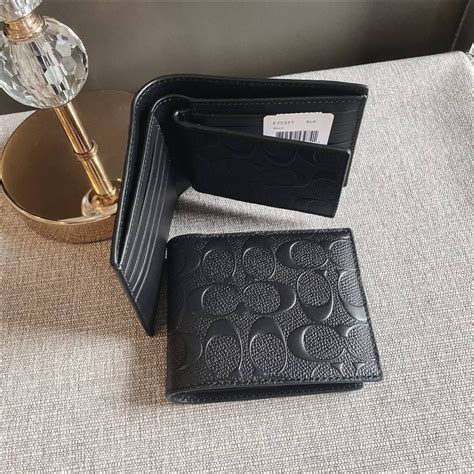 men coach wallet price check.